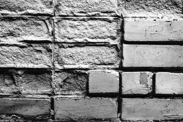 Texture of a brick wall with cracks and scratches which can be used as a background