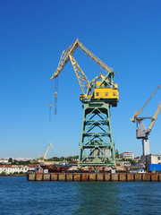 Portal, transshipment crane on the pier of the sea, cargo port. Terminal sea, cargo port.