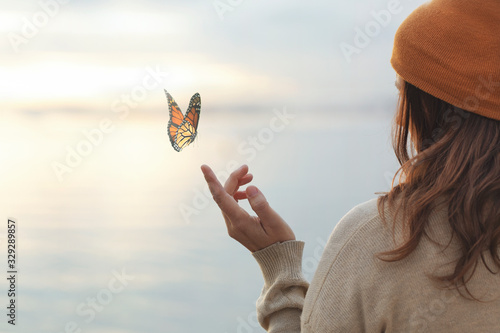 Cuadros en Lienzo colorful butterfly is laying on a woman's hand
