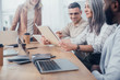 © LIGHTFIELD STUDIOS - cropped view of smiling multicultural colleagues looking at folder during meeting