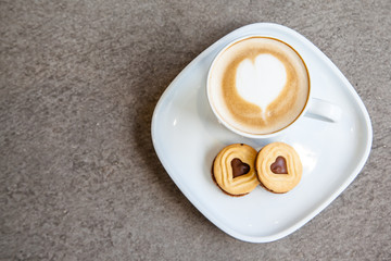 Hot coffee art latte and cookies