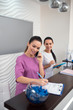 © zinkevych - Dark-haired receptionist of beauty clinic calling client