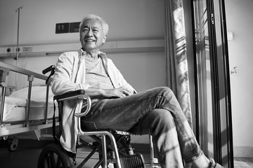 Poster - senior asian man sitting in wheel chair in nursing home