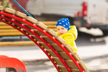 Sticker - Happy little baby boy playing on the playground