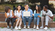 © Prostock-studio - Joyful University Students Sitting At Campus With Laptop And Laughing Together