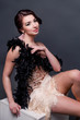© ribalka yuli - Portrait of happy brunette beautiful woman in boa from ostrich feathers . 20's years.