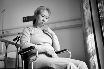 Sticker - sad senior asian woman sitting in wheelchair in nursing home