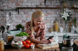 © JustLife - Beautiful woman in kitchen. Young woman writing message on phone.