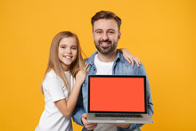 Smiling Bearded Man With Child Baby Girl. Father Little Kid Daughter Isolated On Yellow Background. Love Family Day Parenthood Childhood Concept. Hold Laptop Computer With Blank Empty Screen Hugging.