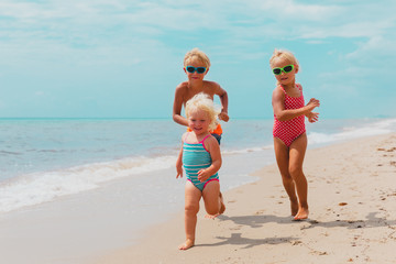 Wall Mural - happy kids enjoy beach vacation, boy and girls have fun