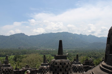 Borobudur temple stupa with a beautiful hill background