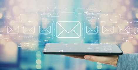 Email concept with man holding a tablet computer