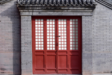 Wall Mural - Red Chinese traditional style wooden door on brick wall