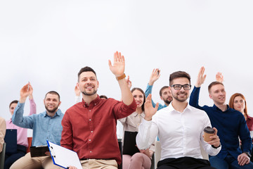 Wall Mural - People raising hands to ask questions at business training on white background