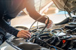© Kanemme6 - Professional mechanic man holding timing belt of a car for repair and preventive maintenance car in garage