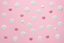 White And Pink Round Medical Pills On A Color Background
