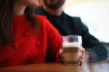 Canvas Print - Lovely couple with fresh aromatic coffee at table in cafe, closeup