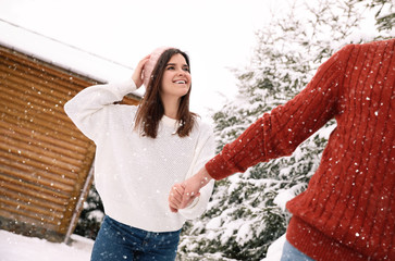 Poster - Lovely couple walking together on snowy day. Winter vacation