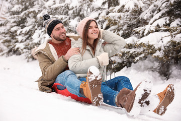  Couple having fun outdoors on snowy day. Winter vacation