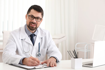 Poster - Portrait of male doctor in white coat at workplace