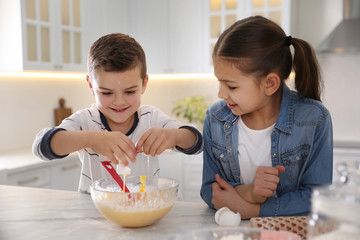 Poster - Cute little children cooking dough together in kitchen