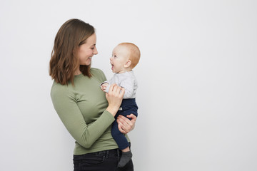 Beautyful mother is holding her happy baby