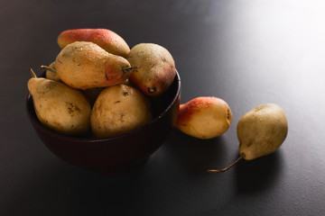 Wall Mural - Fresh juicy appetizing pears in a brown bowl, summer concept, copy space.