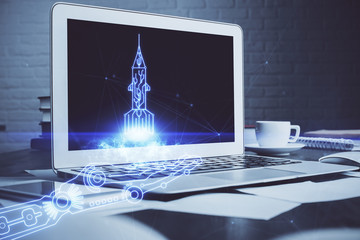 Desktop computer background in office and start up theme hologram drawing. Double exposure. Startup concept.