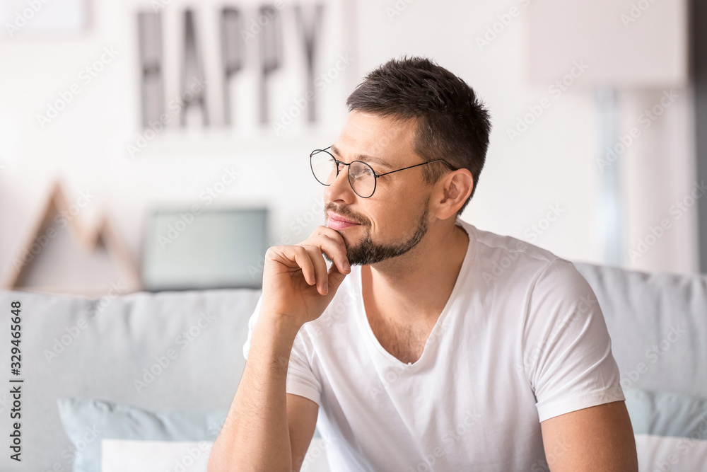 Handsome man wearing glasses at home
