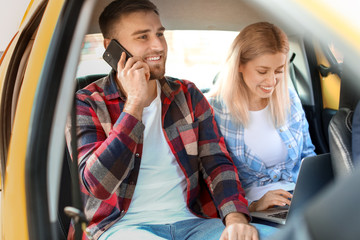 Poster - Portrait of young couple sitting in taxi