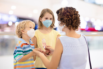 Wall Mural - Mother and child with face mask and hand sanitizer