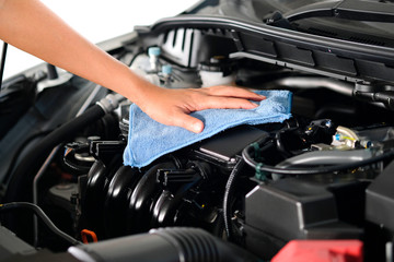 hand of a man holding a blue cloth caring, maintenance car and cleaning And engine car room