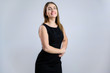 © Вячеслав Чичаев - Business portrait on a white background sympathetic Caucasian woman in a black dress with a smile