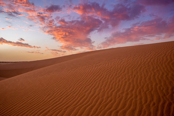 Wall Mural - wonderful, dramatic sky over the sandy desert after sunset
