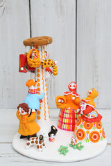 Wall Mural - Ancient russian traditional national handicraft: vintage dymkovo clay toys. Women in russian style. Maslenitsa, slavic holiday. Column. Souvenir from Russia. Folk art and ethnic culture. Dymkovo dolls