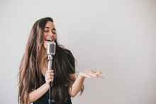 Young Beautiful Woman Sing In Vintage Microphone.