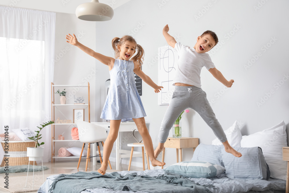 Happy children having fun in bedroom at home - obrazy, fototapety, plakaty 