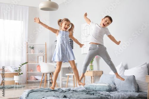 Fotografía Happy children having fun in bedroom at home
