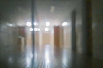 abstract blurred night hospital corridor with the lights on background.