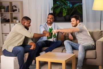 Wall Mural - friendship, leisure and people concept - happy male friends drinking beer at home at night