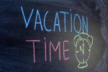 Vacation time near to a painted clock, inscribed in chalk on a blackboard. The concept of home away from home