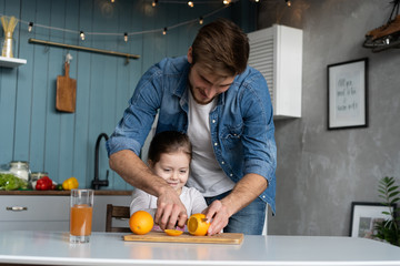 Wall Mural - family, eating and people concept - happy father and daughter having breakfast at home