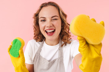 Wall Mural - Positive woman housewife holding sponges