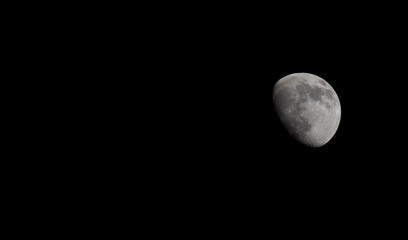 Wall Mural - Closeup of a Three Quarter Moon in a Black Sky