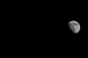 Wall Mural - Closeup of a Three Quarter Moon in a Black Sky
