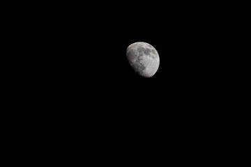 Wall Mural - Closeup of a Three Quarter Moon in a Black Sky