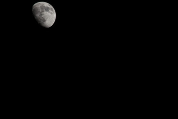 Wall Mural - Closeup of a Three Quarter Moon in a Black Sky