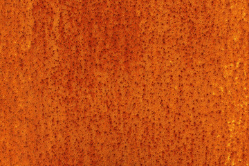 Wall Mural - The surface of an old rusty sheet of metal with small dots. Abstract modern trendy red rusty texture background
