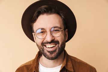 Wall Mural - Happy young unshaved man in hat isolated