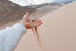trickling desert sand through fingers